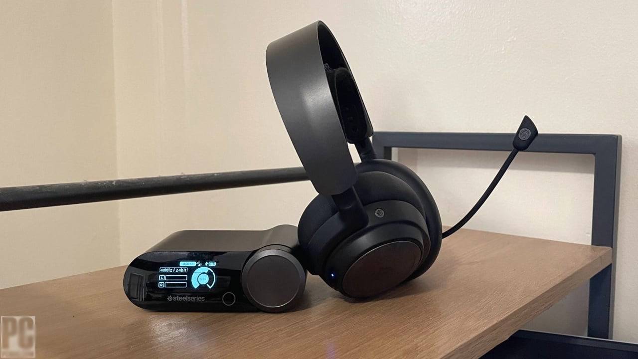  A sleek SteelSeries wireless headset rests on a wooden surface beside a compact control unit, displaying sound settings.