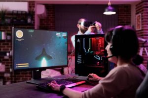 Man using VR headset and woman playing a space-themed computer game in a cozy, tech-equipped room.