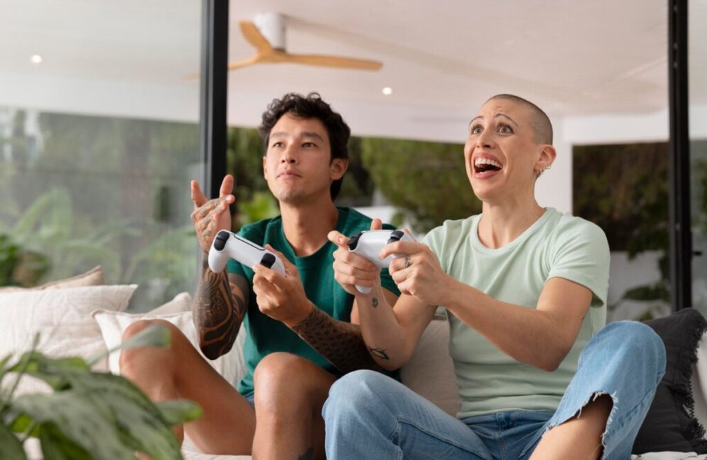 A man and woman excitedly playing video games together in a modern living room.