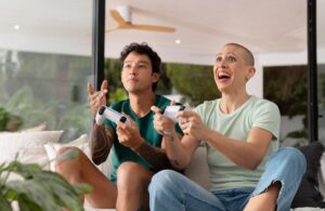 A man and woman excitedly playing video games together in a modern living room.