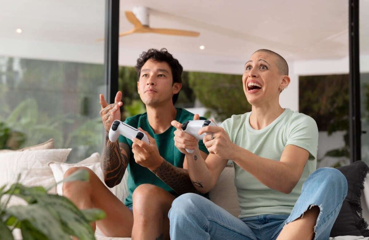 A man and woman excitedly playing video games together in a modern living room.